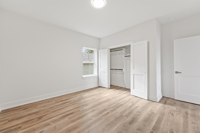 unfurnished bedroom with light hardwood / wood-style floors and a closet