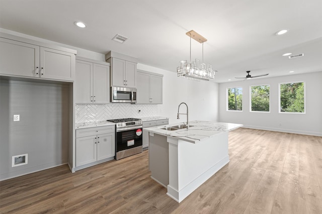 kitchen with sink, gray cabinets, and appliances with stainless steel finishes