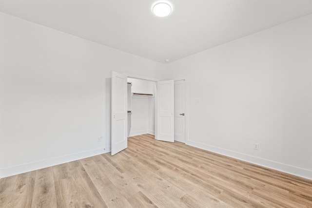 unfurnished bedroom featuring a closet and light hardwood / wood-style flooring