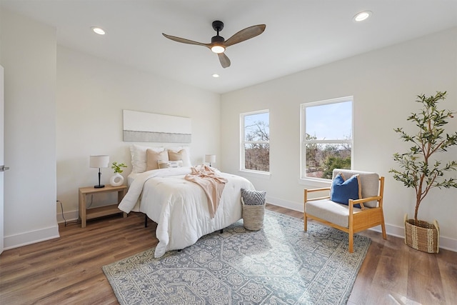 bedroom with dark hardwood / wood-style floors and ceiling fan