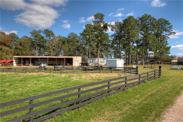 view of yard with an outdoor structure and a rural view