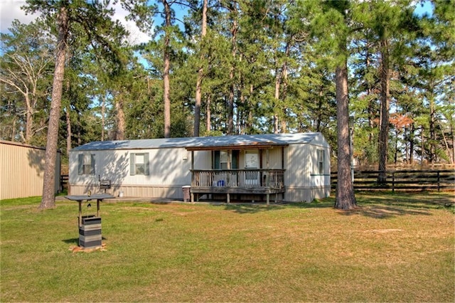 view of front of property with a front yard and a deck