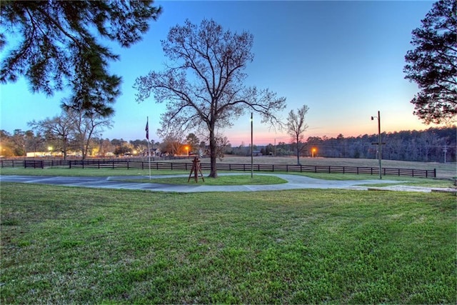 yard at dusk with a rural view