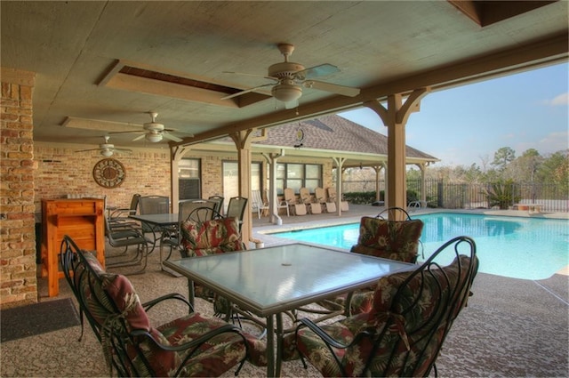 view of swimming pool with a patio and ceiling fan