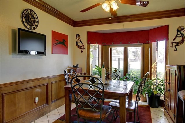 dining area with ornamental molding, light tile patterned floors, and ceiling fan