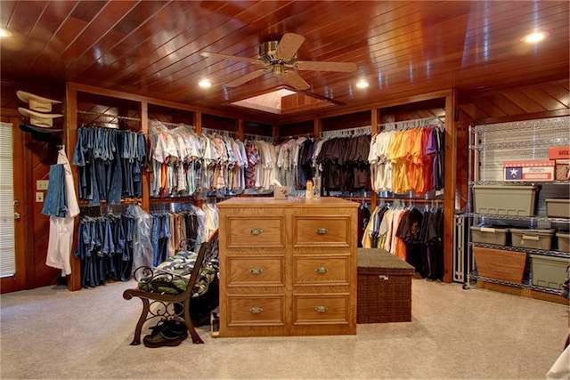 walk in closet featuring light carpet and ceiling fan