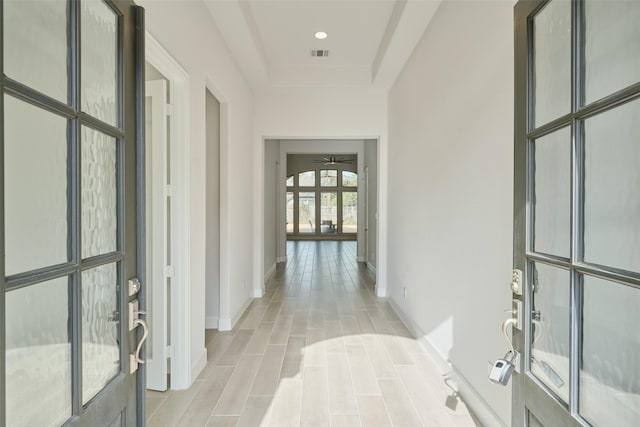 corridor with french doors, recessed lighting, visible vents, wood tiled floor, and baseboards