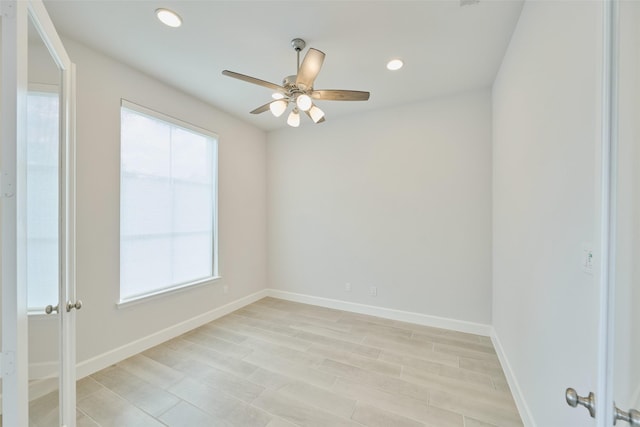 spare room with a ceiling fan, recessed lighting, light wood-style floors, and baseboards