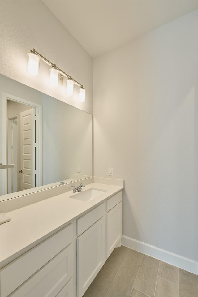 bathroom with baseboards and vanity