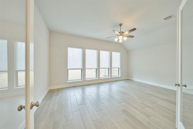 empty room featuring light wood-type flooring, baseboards, visible vents, and french doors