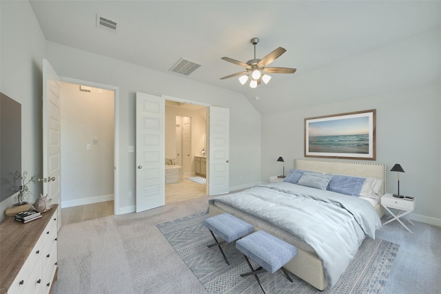 bedroom featuring baseboards, lofted ceiling, visible vents, and light colored carpet