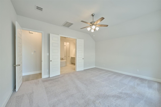 unfurnished bedroom with baseboards, visible vents, ensuite bathroom, and light colored carpet