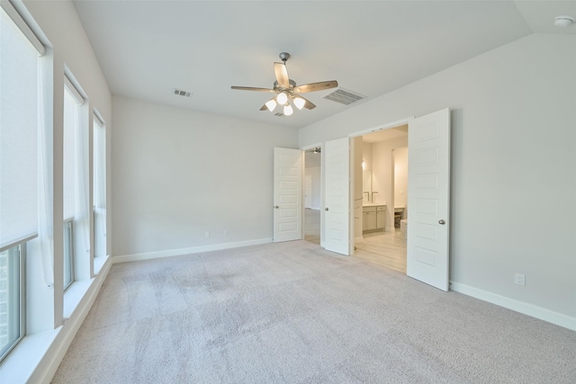 unfurnished bedroom with light carpet, visible vents, and baseboards