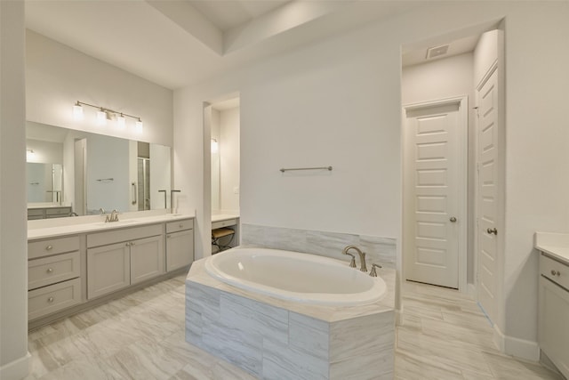 bathroom with vanity and a bath