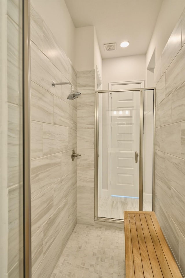 bathroom featuring a stall shower and visible vents