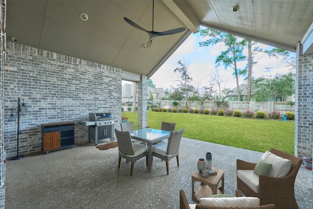 view of patio with a ceiling fan, outdoor dining space, a fenced backyard, and grilling area