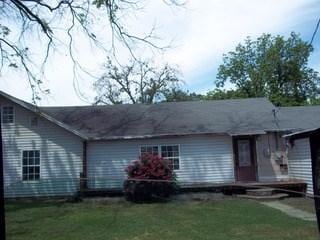 back of house with a yard