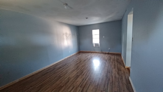 spare room with dark hardwood / wood-style flooring