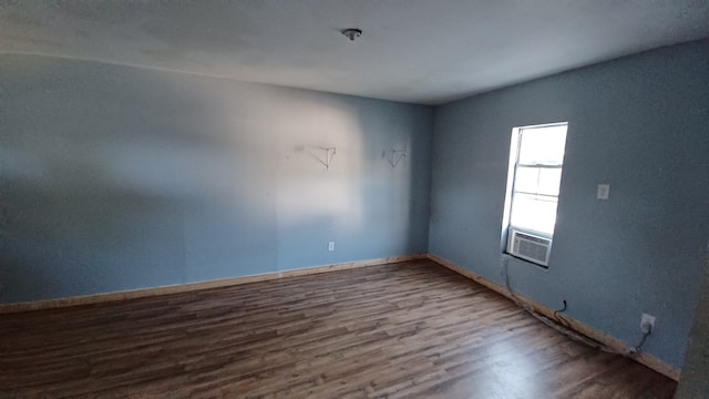 spare room featuring hardwood / wood-style floors and cooling unit