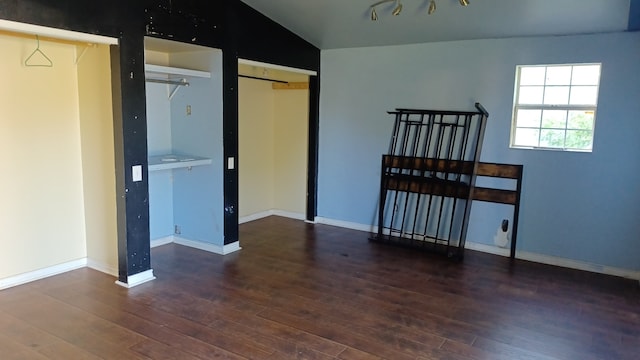 bedroom with lofted ceiling and dark hardwood / wood-style floors