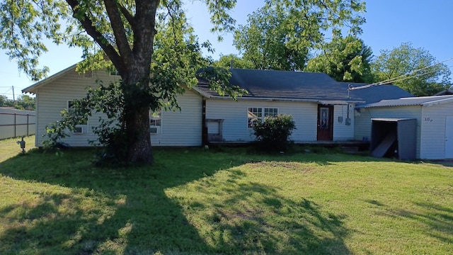 back of house with a lawn