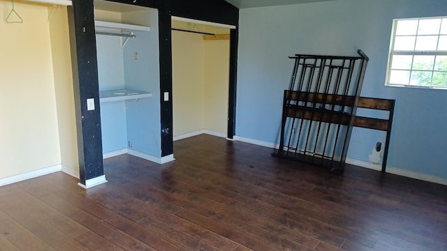 unfurnished bedroom featuring dark hardwood / wood-style flooring