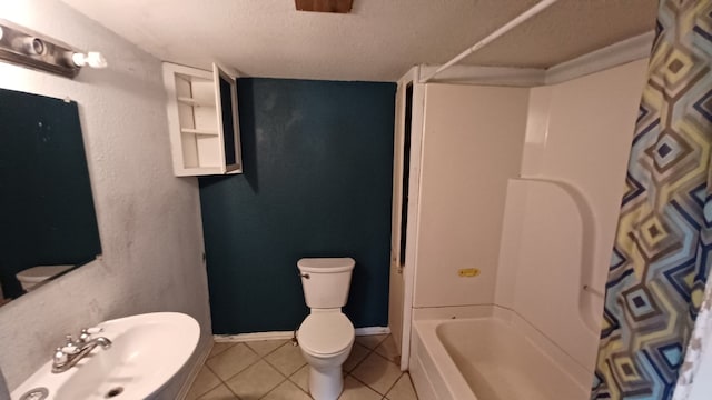 full bathroom featuring tile patterned floors, toilet, sink, a textured ceiling, and shower / bath combination with curtain