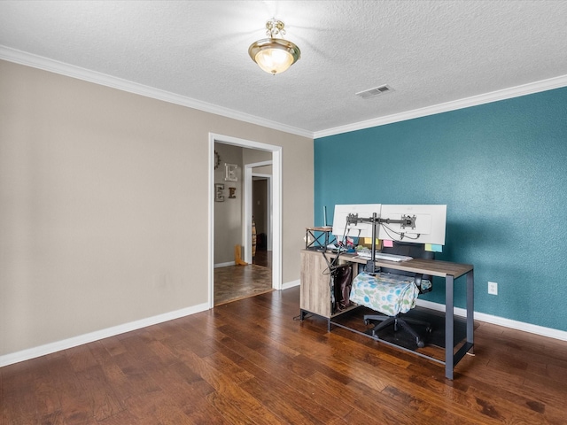 office space with ornamental molding, visible vents, baseboards, and wood finished floors