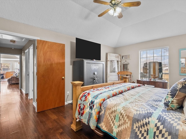 bedroom with lofted ceiling, ceiling fan, wood finished floors, baseboards, and attic access