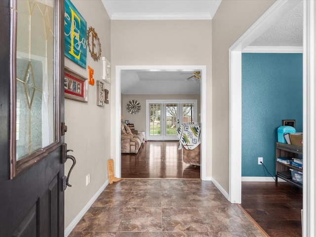 foyer featuring ceiling fan, wood finished floors, baseboards, french doors, and ornamental molding