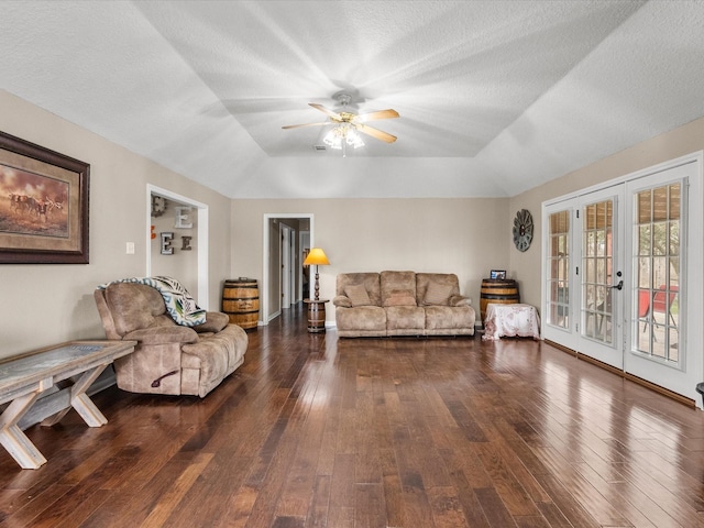 living room featuring hardwood / wood-style flooring, a textured ceiling, and french doors