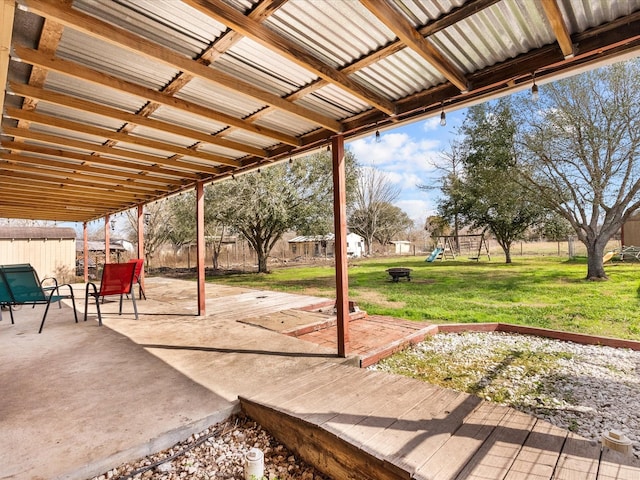 view of patio featuring a fenced backyard and a playground