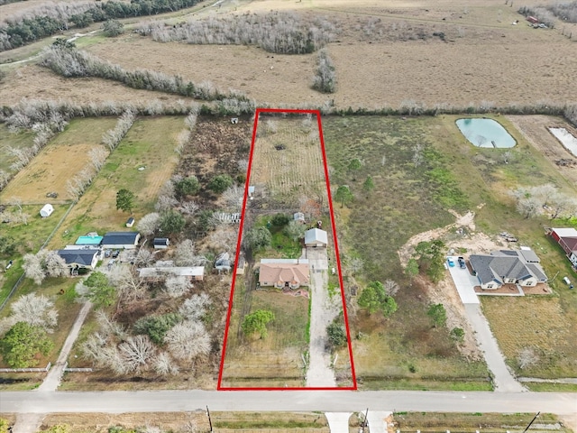 birds eye view of property with a rural view