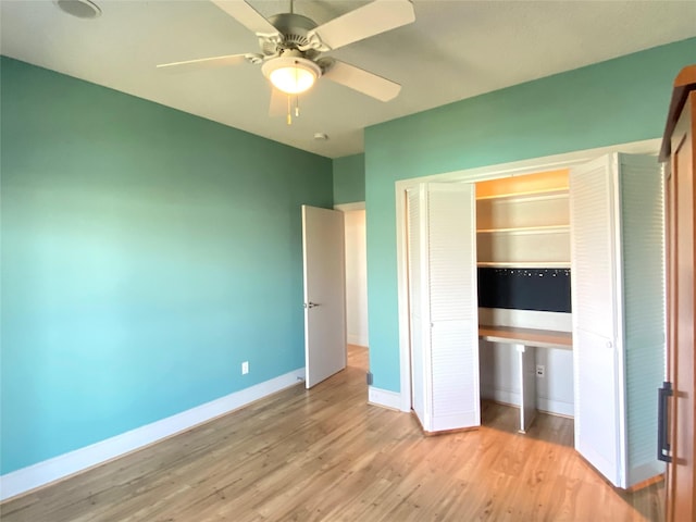 unfurnished bedroom with ceiling fan, light wood-type flooring, and a closet