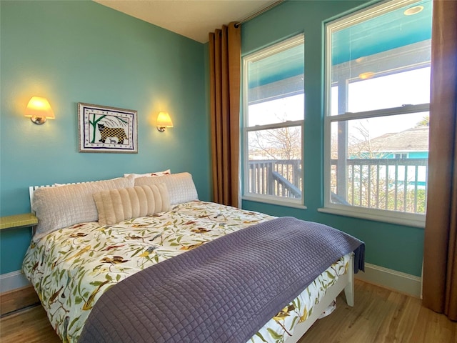 bedroom featuring hardwood / wood-style floors and multiple windows