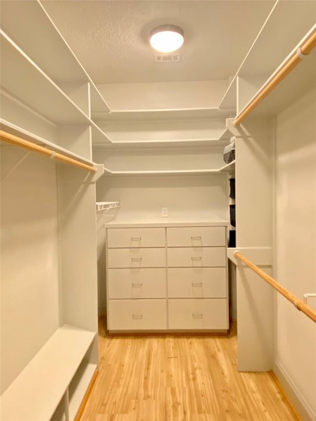 walk in closet featuring light hardwood / wood-style floors