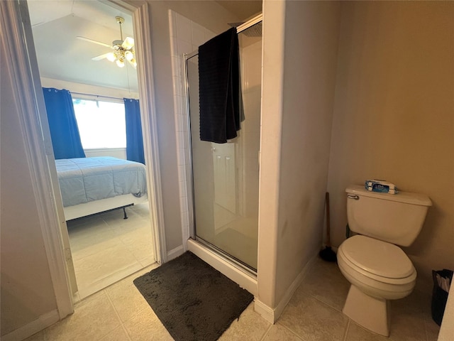 bathroom with ceiling fan, toilet, a shower with shower door, and tile patterned flooring