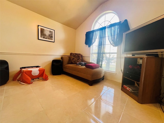 sitting room featuring tile patterned flooring and vaulted ceiling