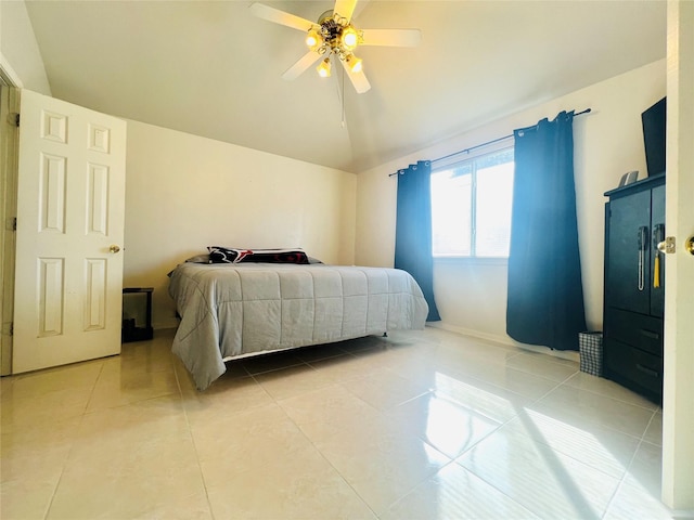 bedroom with ceiling fan, tile patterned floors, and lofted ceiling