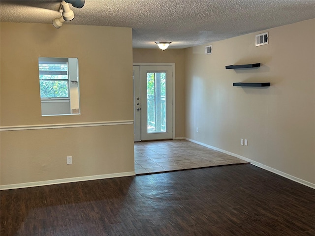 entryway featuring hardwood / wood-style flooring and a textured ceiling