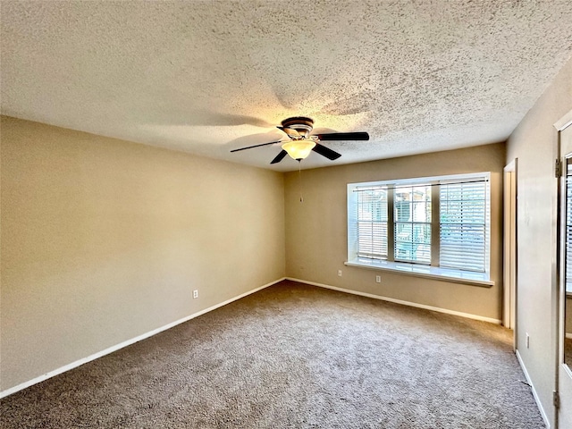 carpeted empty room featuring a textured ceiling and ceiling fan