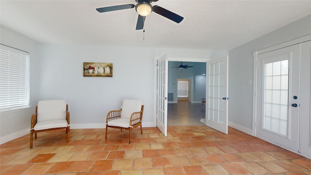 sitting room with french doors and ceiling fan