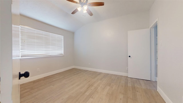 spare room with vaulted ceiling, ceiling fan, and light hardwood / wood-style floors