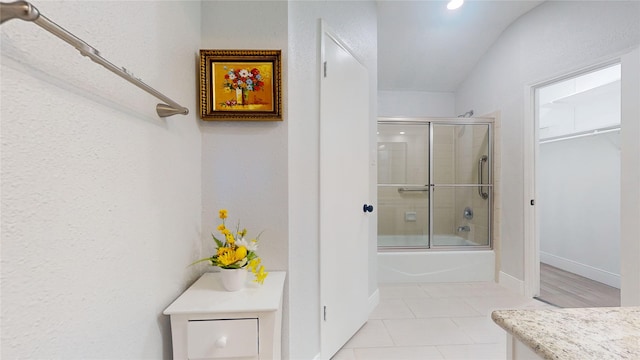 bathroom featuring vanity, tile patterned floors, and combined bath / shower with glass door