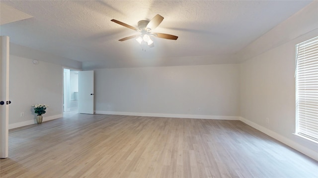 unfurnished room featuring ceiling fan, plenty of natural light, a textured ceiling, and light hardwood / wood-style flooring