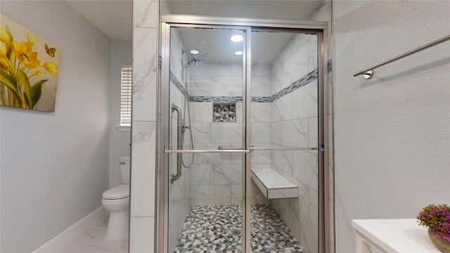 bathroom with walk in shower and toilet