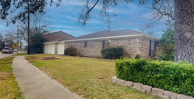 view of side of home with a yard