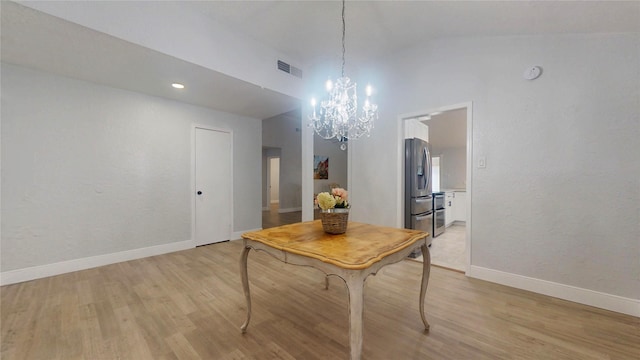 dining room with lofted ceiling and light wood-type flooring