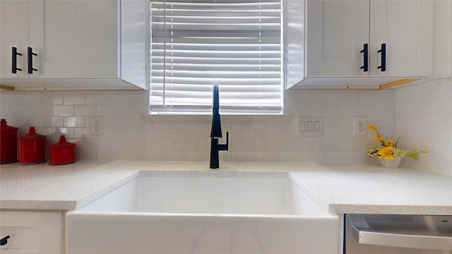 details with sink, dishwasher, backsplash, light stone counters, and white cabinets