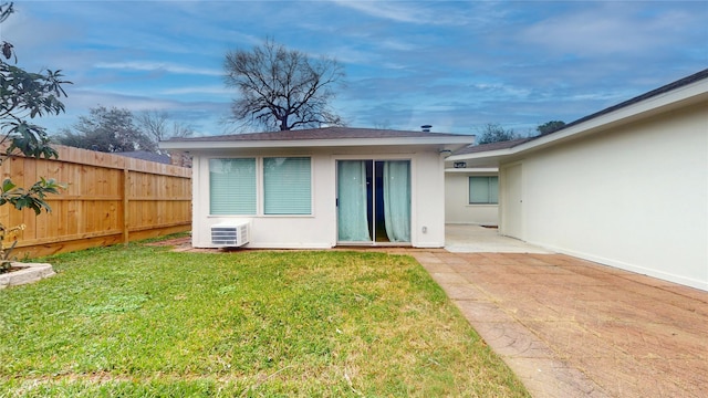 rear view of house featuring a patio and a lawn